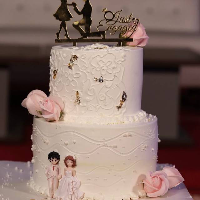 Two-tier white engagement cake